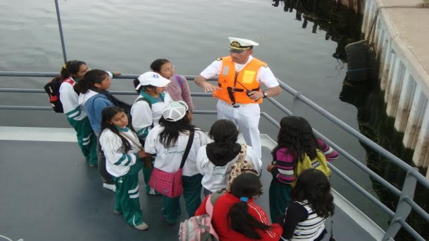 Foto de estudiantes de secundaria con un naval de la Armada Boliviana